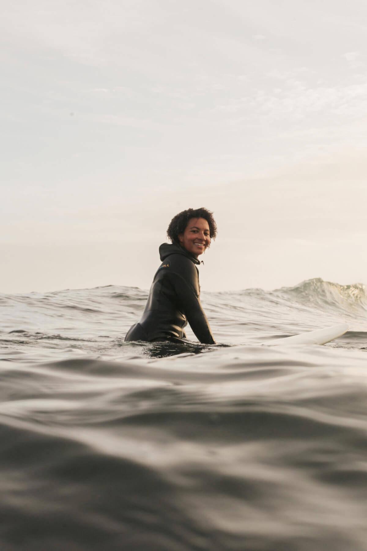 Woman waiting for a wave on a surfboard