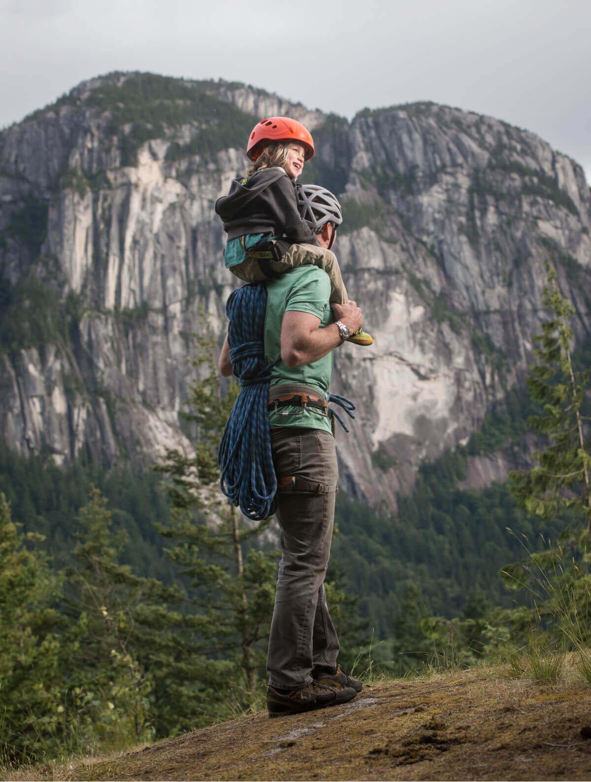 Man hiking with a child on his shoulders